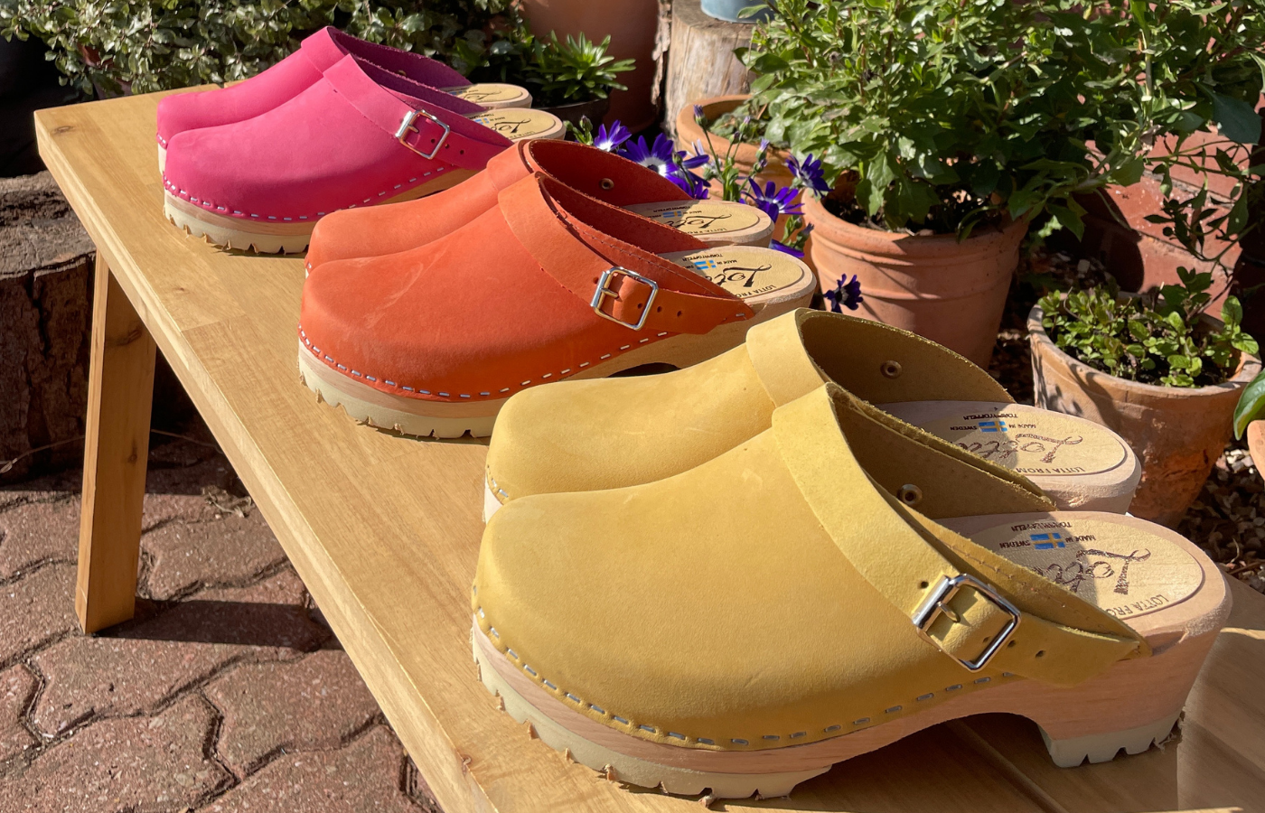 colourful clogs for spring, pink, orange and yellow classic clogs with a tractor sole