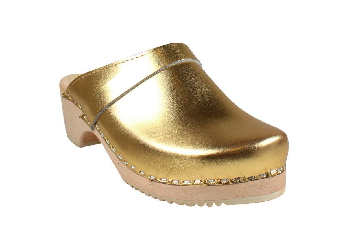 Gold clogs Women's clogs shoes in gold on wooden clogs base. 