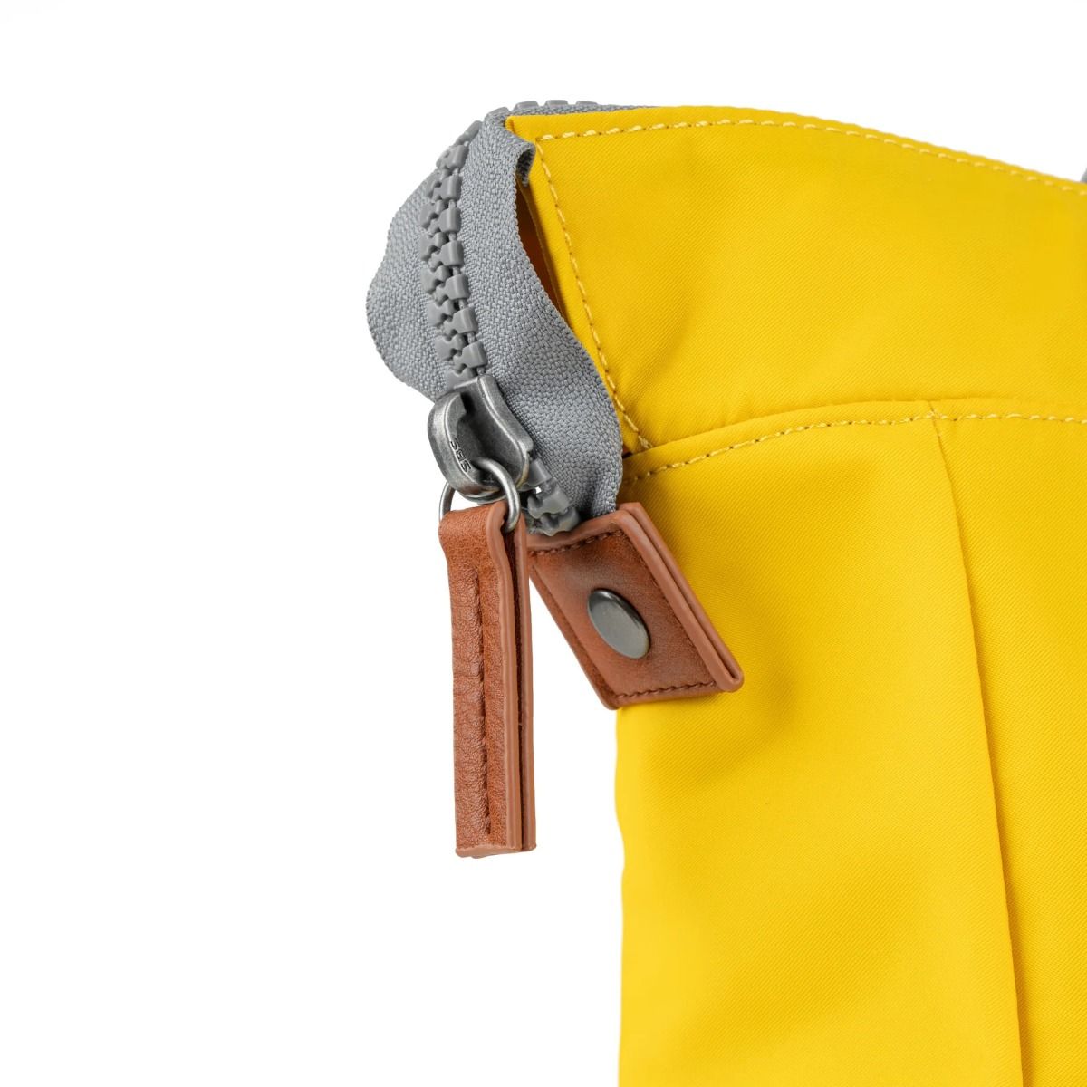 Roka Bantry B rucksack Bag in mustard available at Lotta from Stockholm zip detail a mustard yellow bag with grey straps and brown accents on zip pulls
