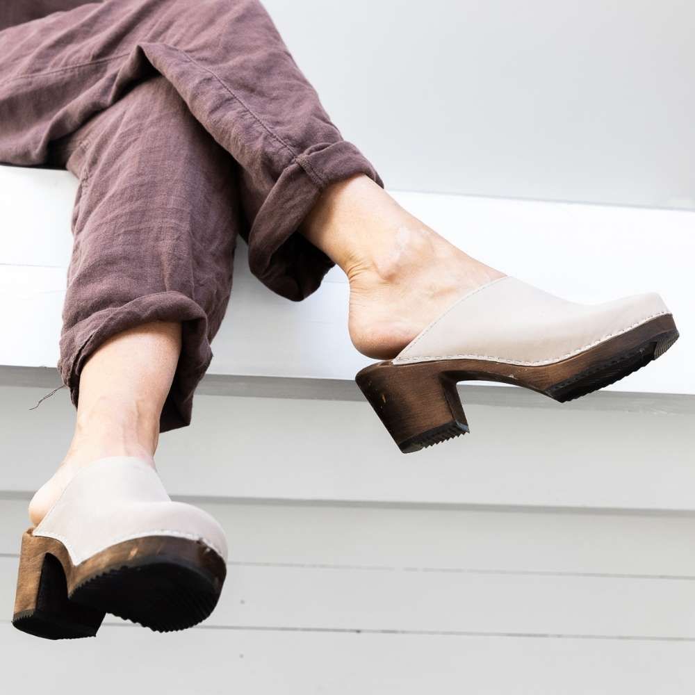 Wearing High Heeled Clogs Oatmeal Oiled Nubuck with a dark wooden base by Lotta from Stockholm