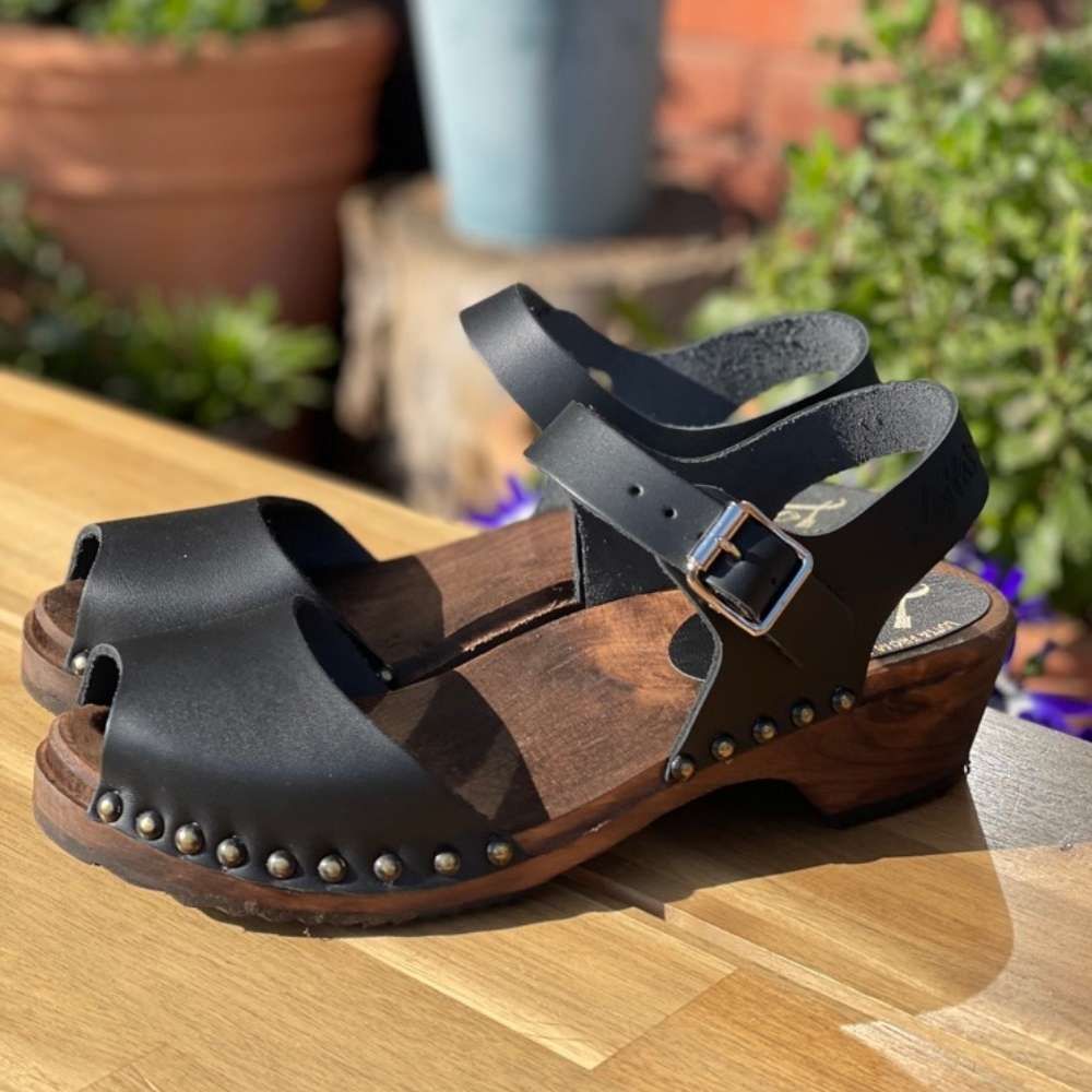 Low Wood Open Stud Black Leather Clogs on Brown Base