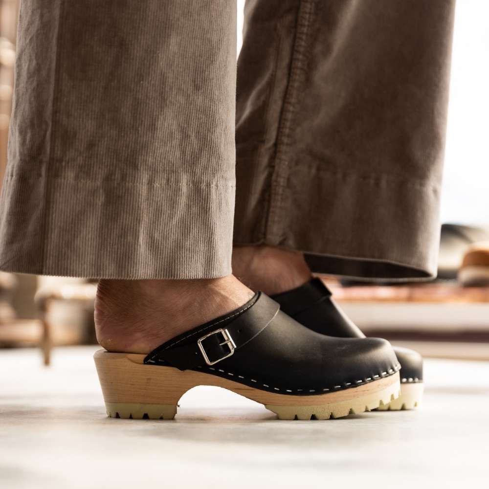 Classic Black Leather Clogs with Strap and Tractor Sole